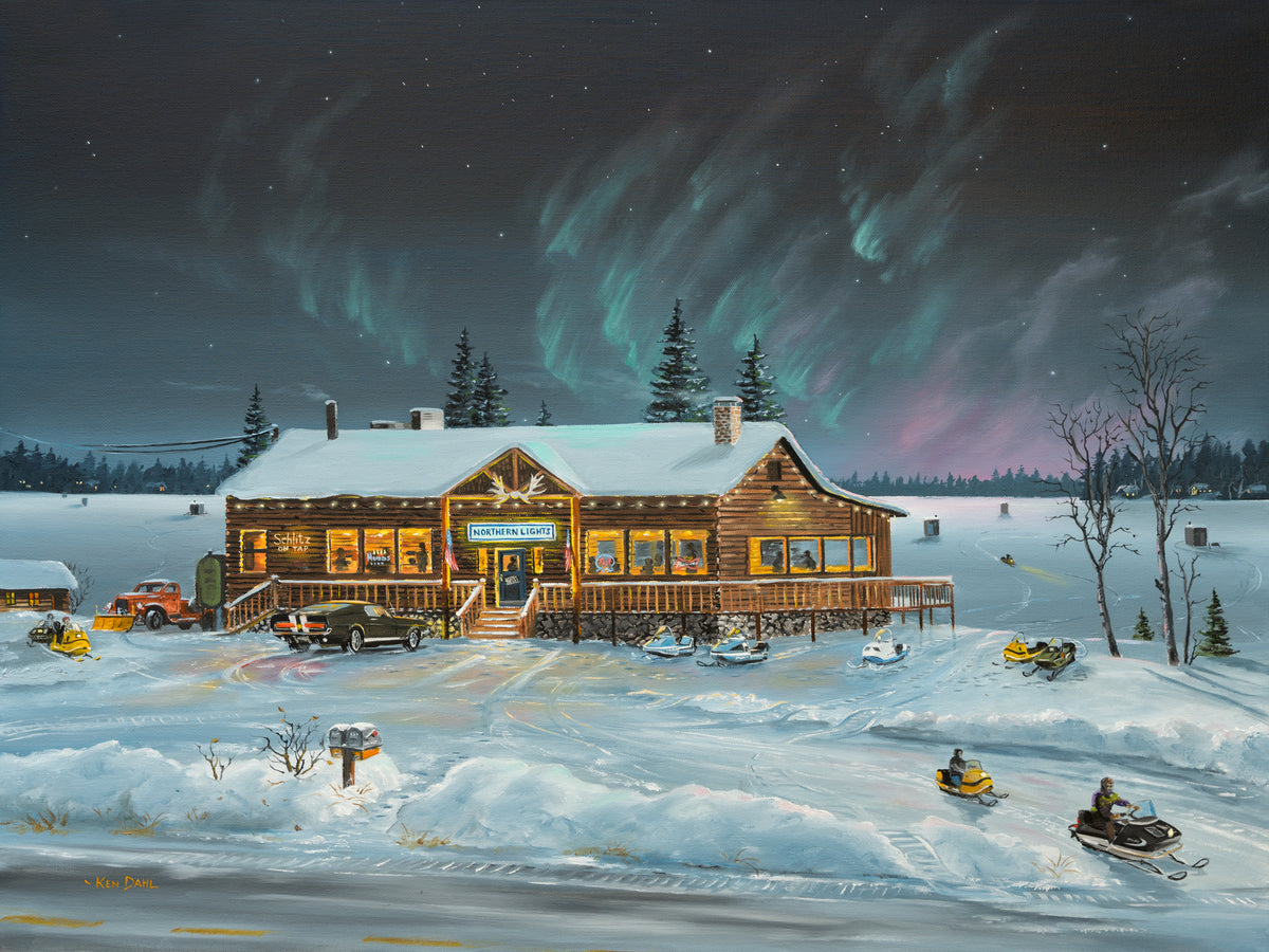 Northern Lights Lakeside Tavern – oil painting by Ken Dahl: a log tavern with warmly lit windows beside a frozen lake dotted with fish houses, snowmobiles parked outside, under green and pink northern lights